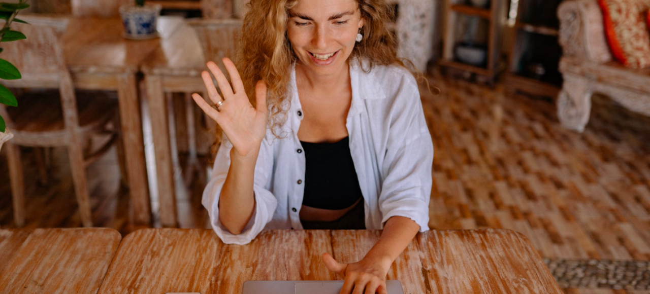 A woman takes an online class while sitting in her living room