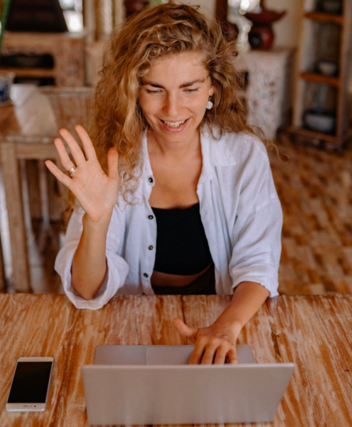 A woman takes an online class while sitting in her living room