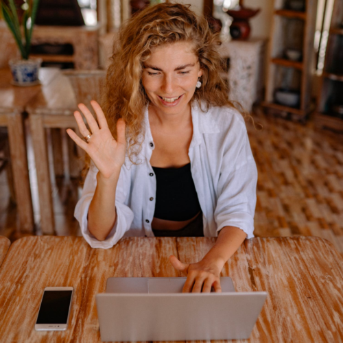 A woman takes an online class while sitting in her living room