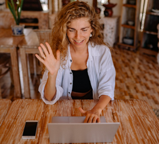 A woman takes an online class while sitting in her living room