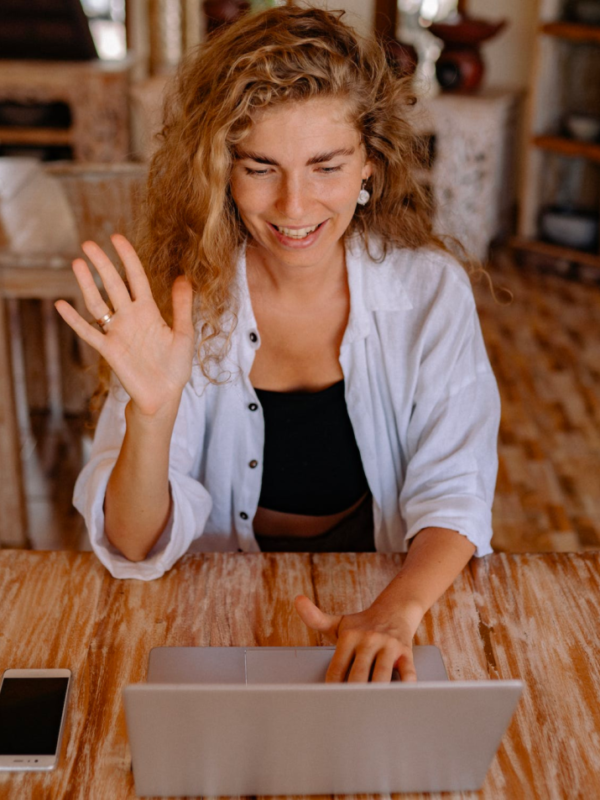 A woman takes an online class while sitting in her living room