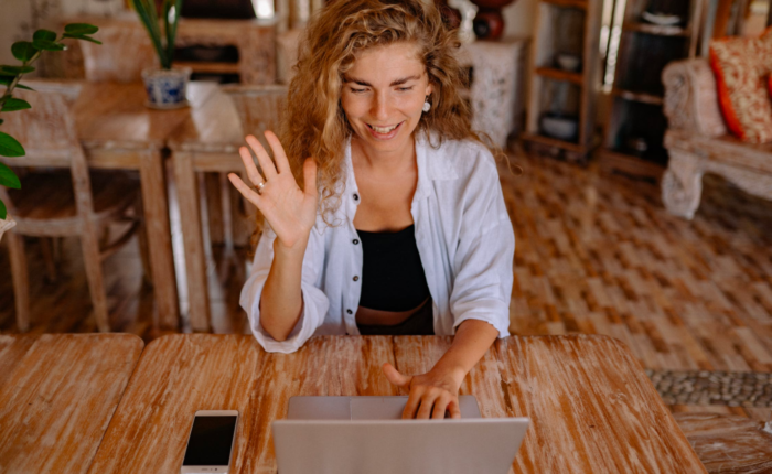 A woman takes an online class while sitting in her living room