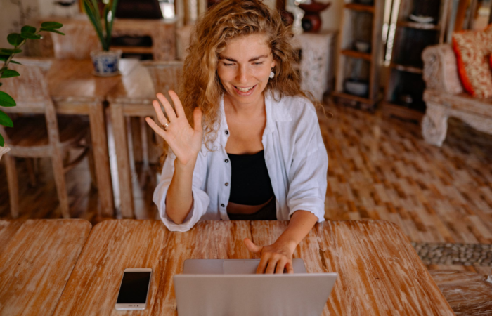 A woman takes an online class while sitting in her living room