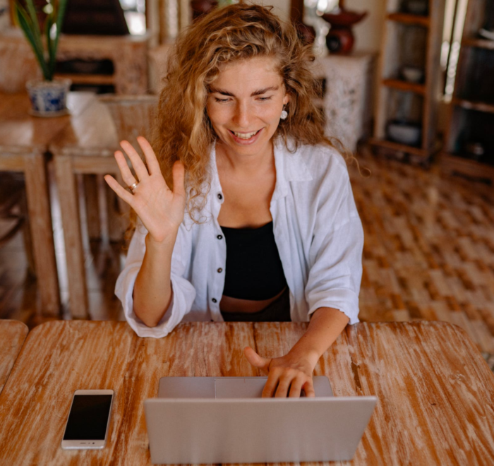 A woman takes an online class while sitting in her living room