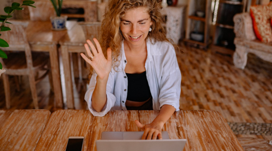 A woman takes an online class while sitting in her living room