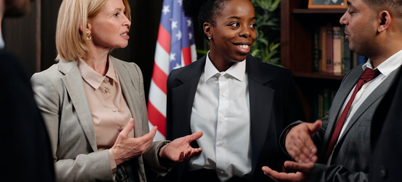 A group of paralegals talk and communicate during a meeting