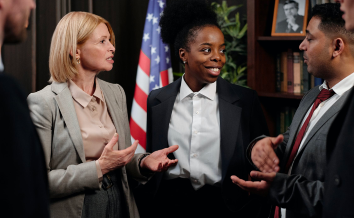 A group of paralegals talk and communicate during a meeting