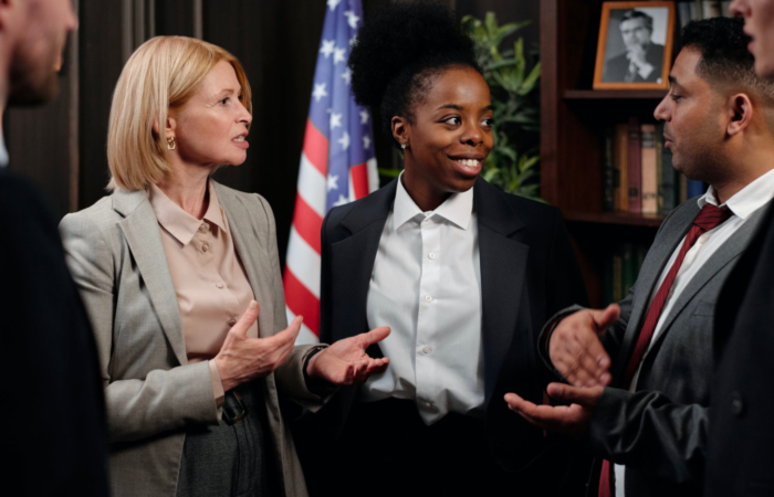 A group of paralegals talk and communicate during a meeting