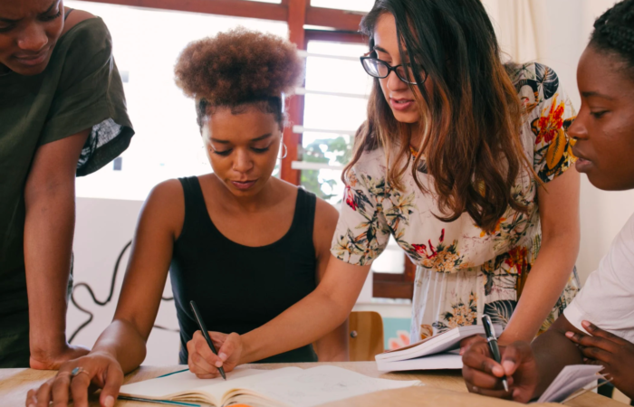 A business owner guides her team members