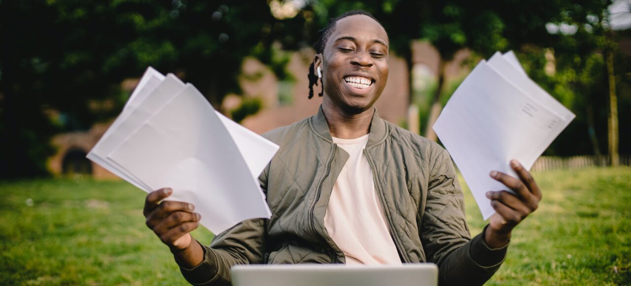 a man happy with his grades after learning academic essay writing skills