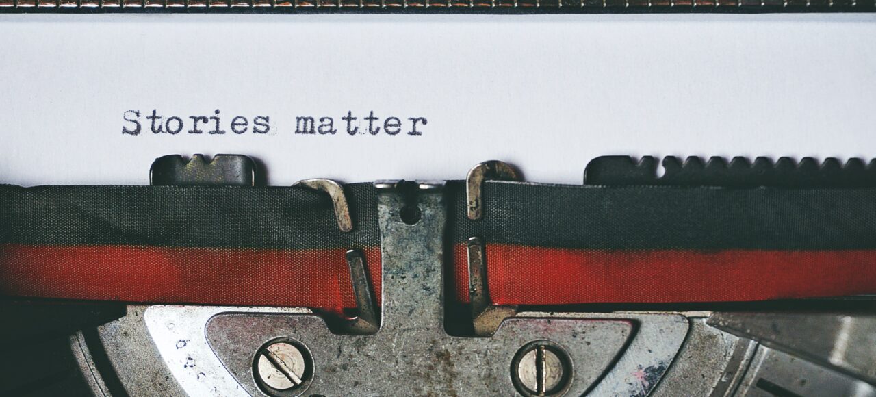 a typewriter that says "stories matter"
