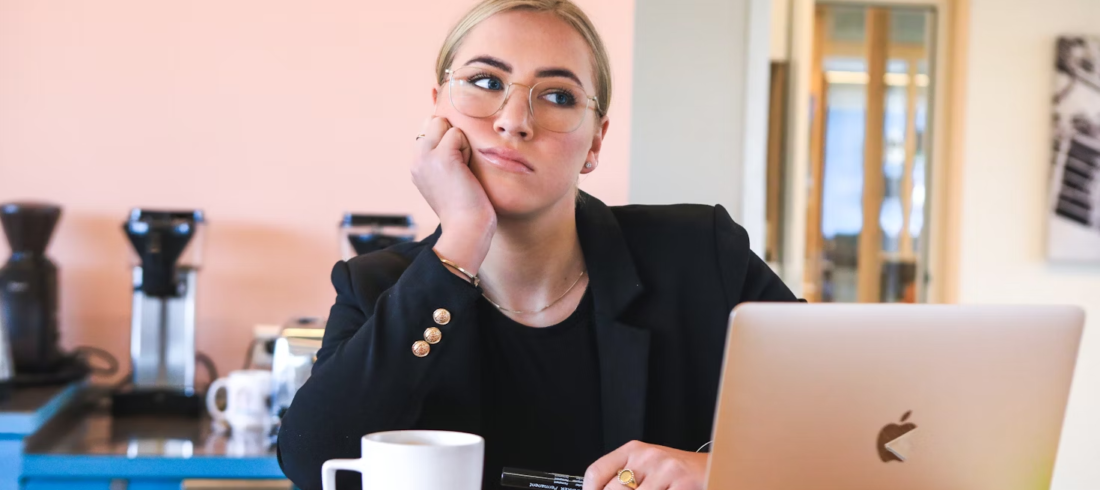 A woman looks tired and distracted at work