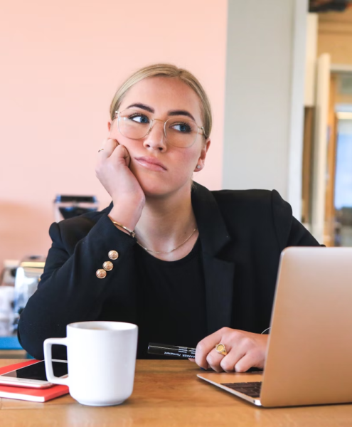 A woman looks tired and distracted at work