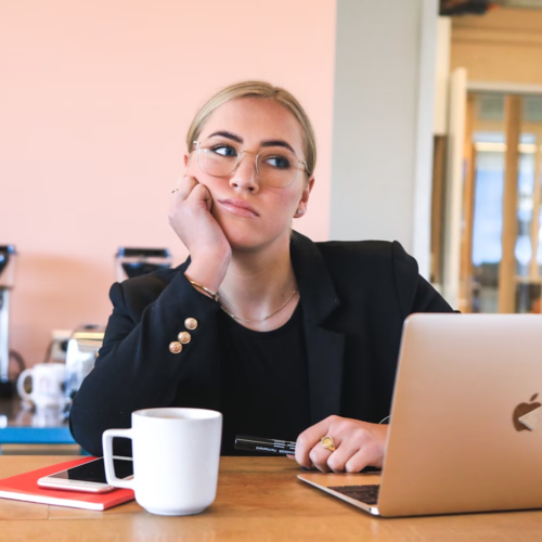 A woman looks tired and distracted at work