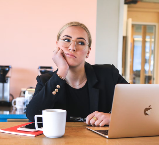 A woman looks tired and distracted at work