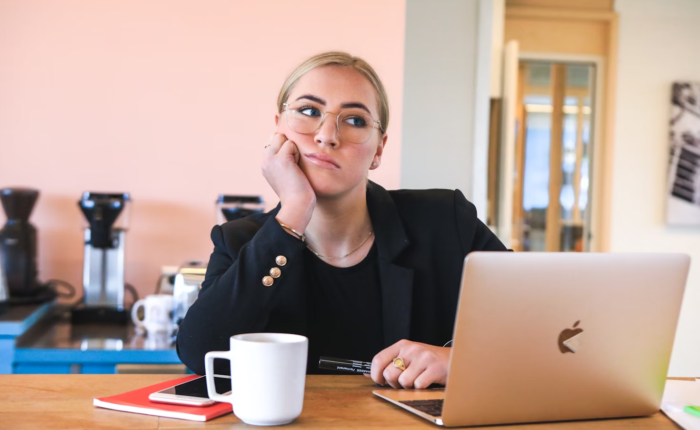 A woman looks tired and distracted at work