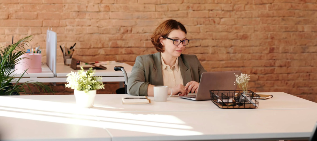 A grant writer works at her desk