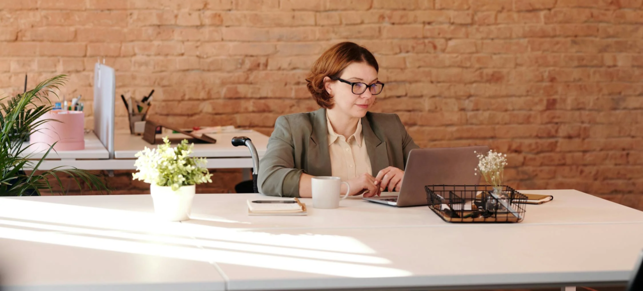 A grant writer works at her desk