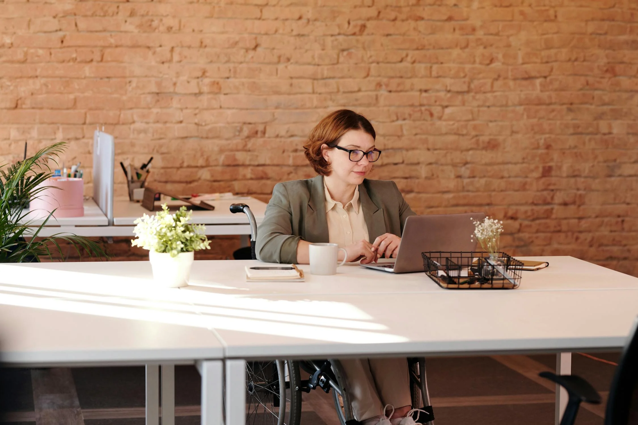 A grant writer works at her desk