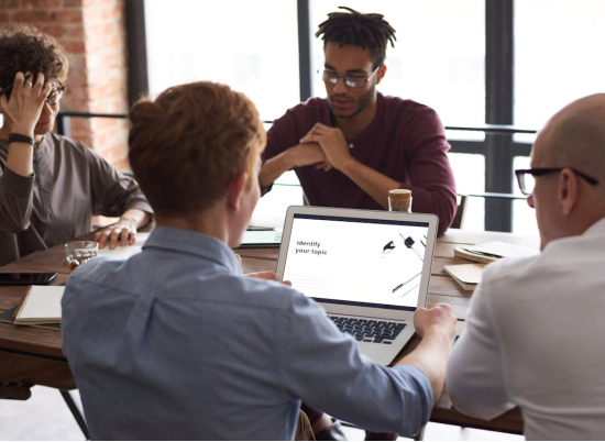 A group of people sitting and working together