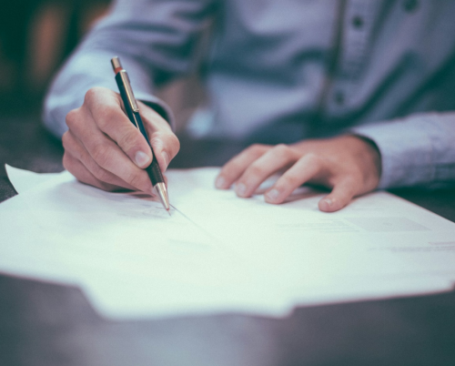 a man writing on paper