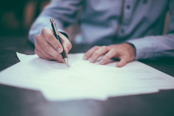 a man writing on paper