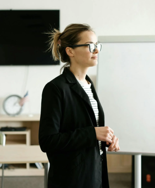 A motivational speaker addresses a room