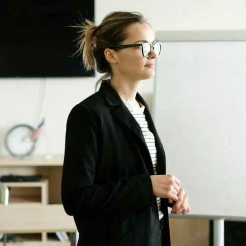 A motivational speaker addresses a room