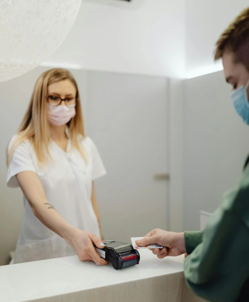 A patient pays at a reception