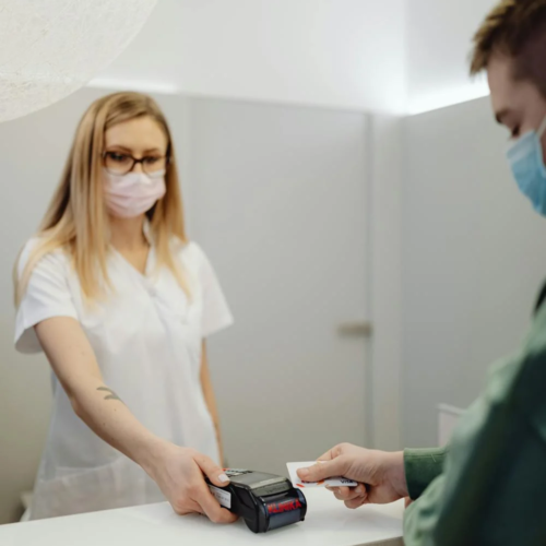 A patient pays at a reception