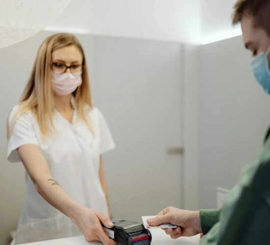 A patient pays at a reception