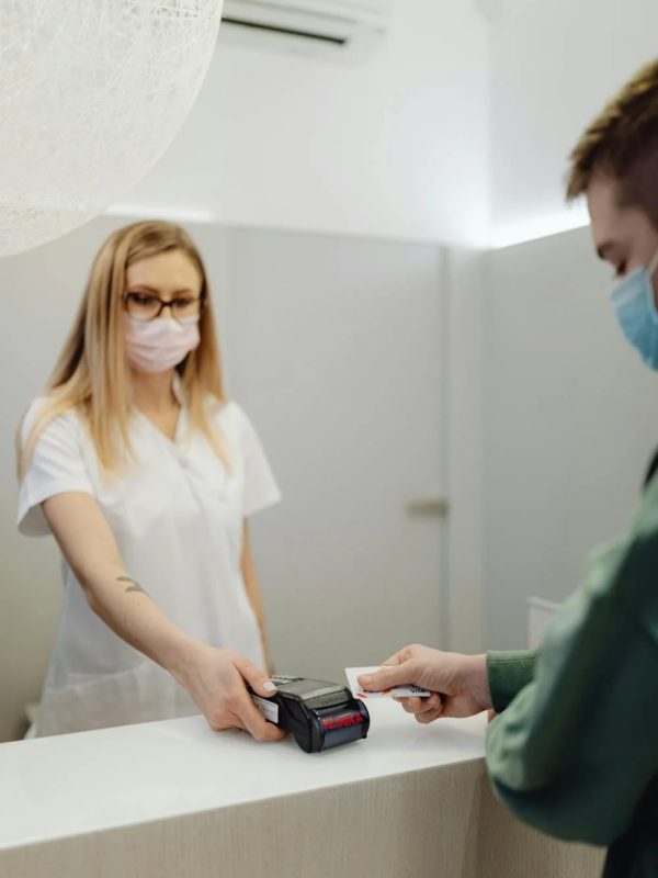 A patient pays at a reception