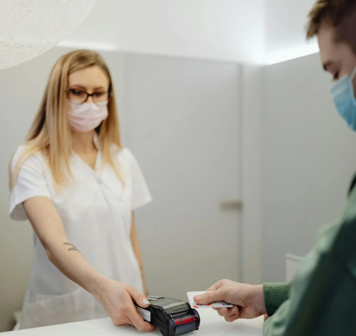 A patient pays at a reception