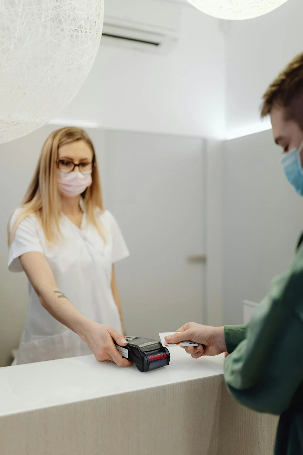 A patient pays at a reception